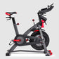 Schwinn IC4 indoor cycling bike with black frame, red and black seat, handlebars, and pedals on white background