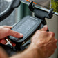 Schwinn IC4 bike display console with digital screen held in user's hands during indoor cycling workout
