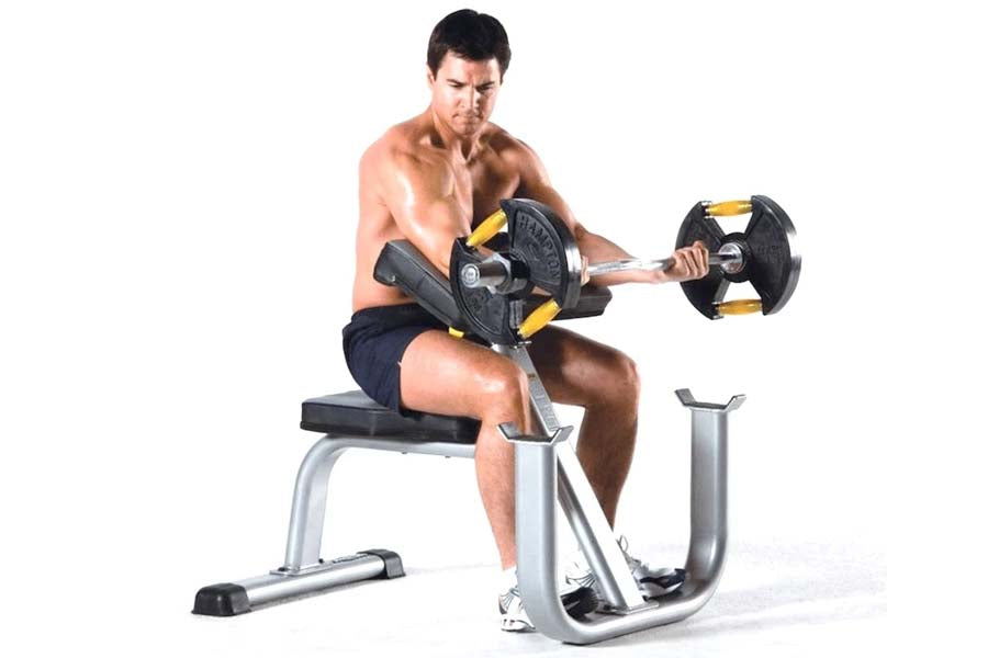 Man performing seated bicep curl with black and yellow dumbbells on silver and black weight bench