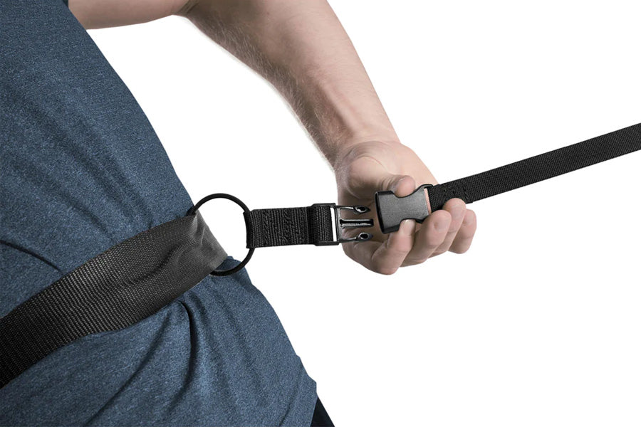 Black nylon resistance training chute with quick-release buckle, worn by model against blue shirt