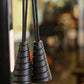 Black spiral jump rope handles with gold accents and braided cords, close-up view