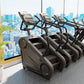 Row of black and gray StairMaster Gauntlet 4G StepMills with digital displays in modern gym with city skyline view