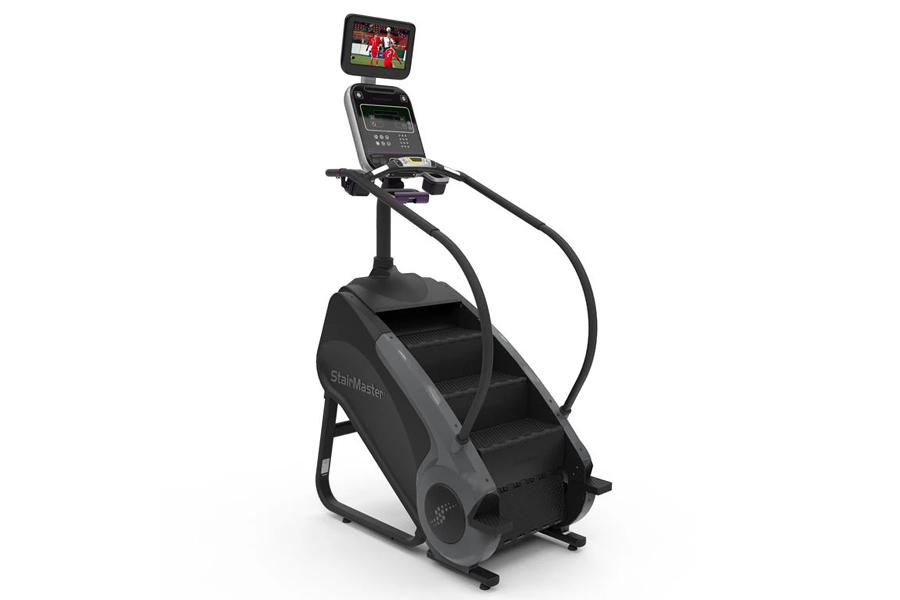 Black StairMaster Gauntlet 8G StepMill with digital console and tablet holder displaying workout content, on white background