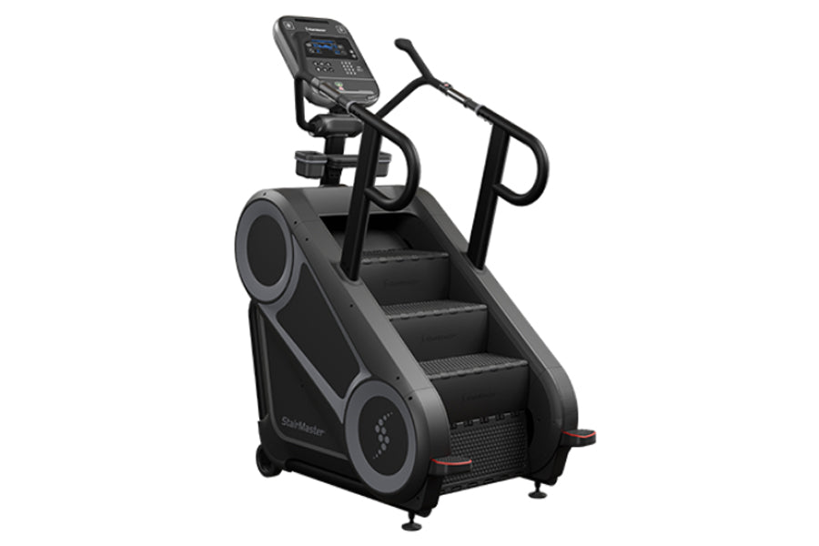 Black StairMaster 8Gx Gauntlet stair stepper with digital display console, handrails, and stepped climbing surface on white b