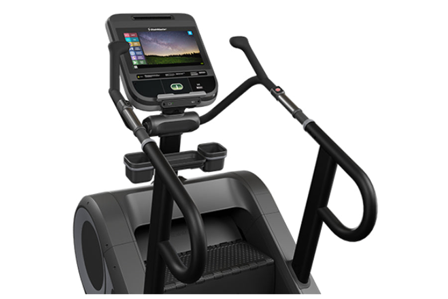 Black StairMaster 8Gx Gauntlet stair stepper with digital display console, handlebar grips, and pedal platform on white backg