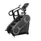 StairMaster 8Gx Gauntlet stair stepper with black frame, gray accents, digital console, and handlebar grips on white backgrou