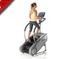 Woman wearing yellow tank top and black capris exercising on StairMaster SM3 StepMill with digital display console