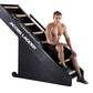 Jacobs Ladder black climbing machine with male model demonstrating proper posture on equipment
