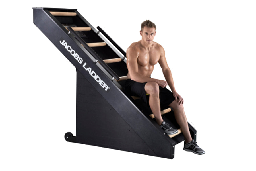 Jacobs Ladder black climbing machine with male model demonstrating proper posture on equipment