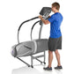 Man in blue shirt using gray StairMaster SM3 StepMill with dual handles on white background