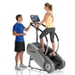 StairMaster SM3 StepMill with digital display, shown with woman exercising and man standing beside it on white background