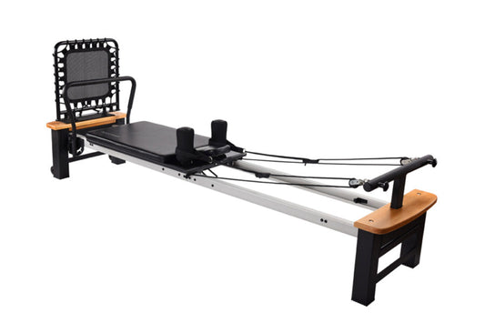 Stamina Pilates Reformer with black mesh headrest, black platform, silver rail, wooden footbar and headpiece, resistance cabl