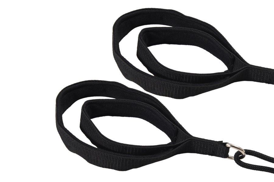Black nylon straps with metal buckle attachment for pilates reformer, on white background