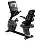 Stationary recumbent exercise bike with black frame, gray base, mesh back support, digital console display, and red accent de