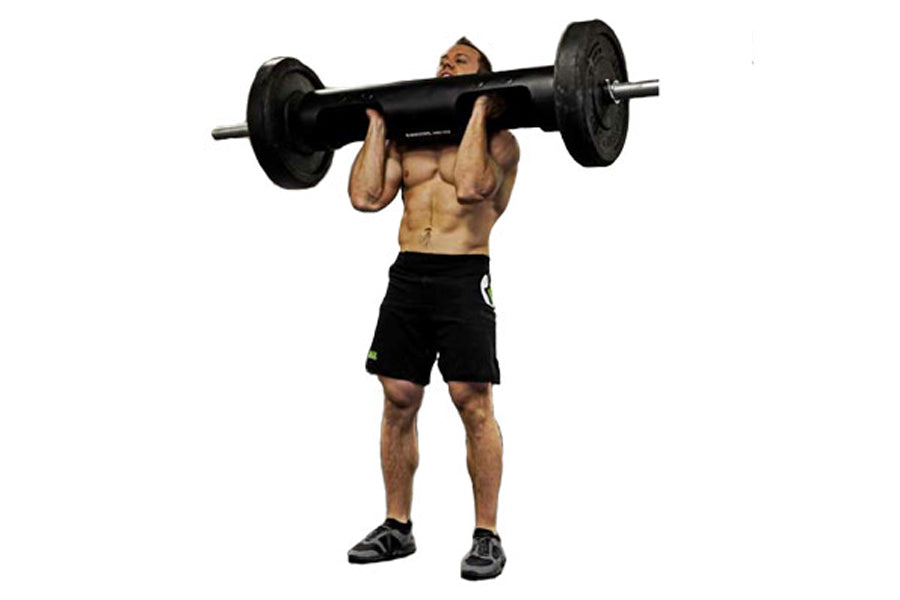 Muscular man performing overhead press with black metal barbell loaded with weight plates on white background