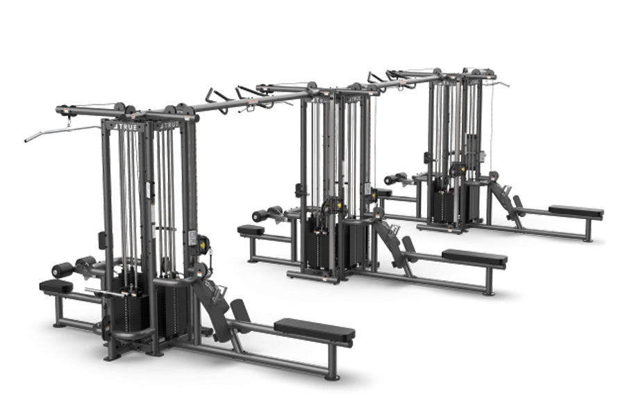 TRUE TMS12000 dual modular cable crossover system with black frame, vertical cable towers, and attached benches on white back