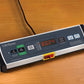 LifeSpan under desk treadmill with digital display showing 0024, control buttons, and black power cord on wooden surface