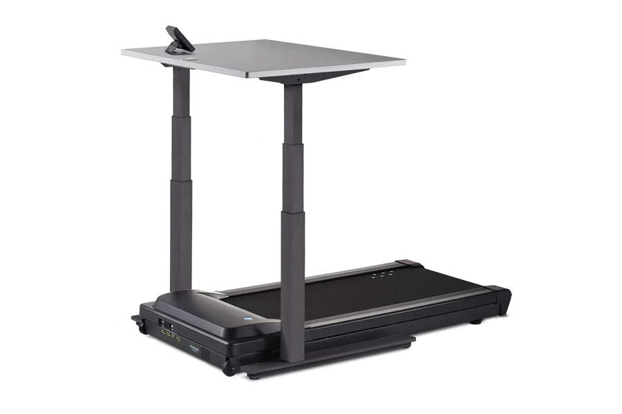 Black desk treadmill with gray rectangular work surface, adjustable dual columns, and integrated treadmill belt base on white