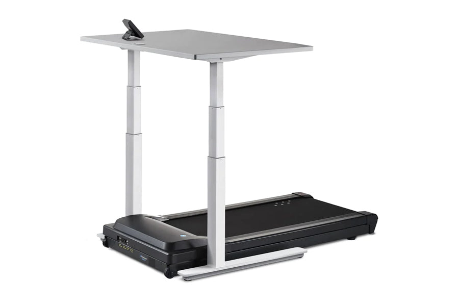 LifeSpan TR1000-Omni desk treadmill with black belt and gray desktop surface on adjustable white metal frame with clip-on mon