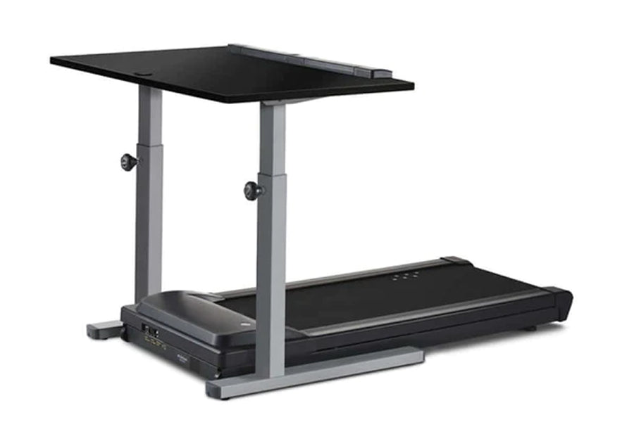 Black treadmill desk with adjustable gray metal frame and dual black work surfaces, on white background
