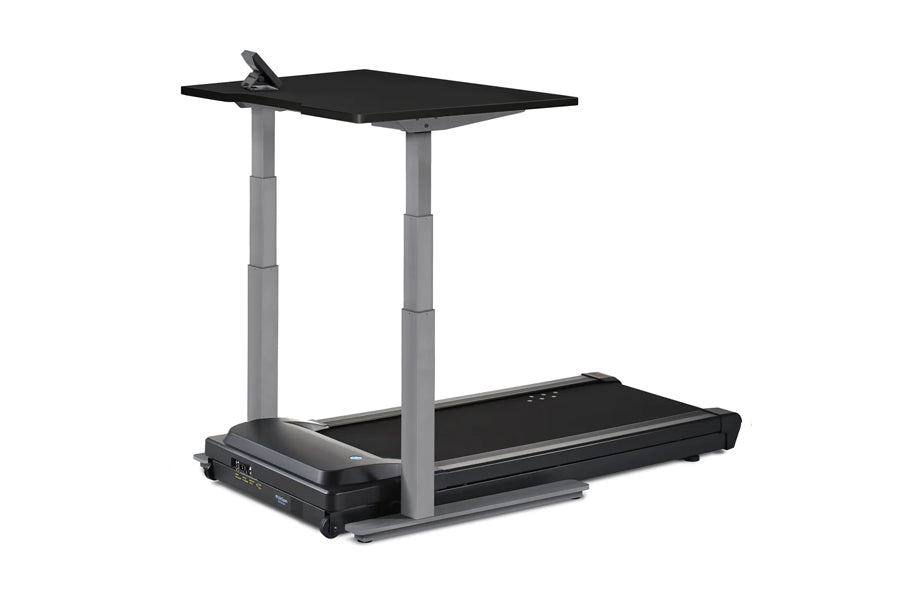 Black and gray desk treadmill with adjustable height columns, black platform, and upper work surface on white background