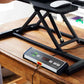 Black under-desk treadmill with digital control panel and folding frame on wooden desk in office setting