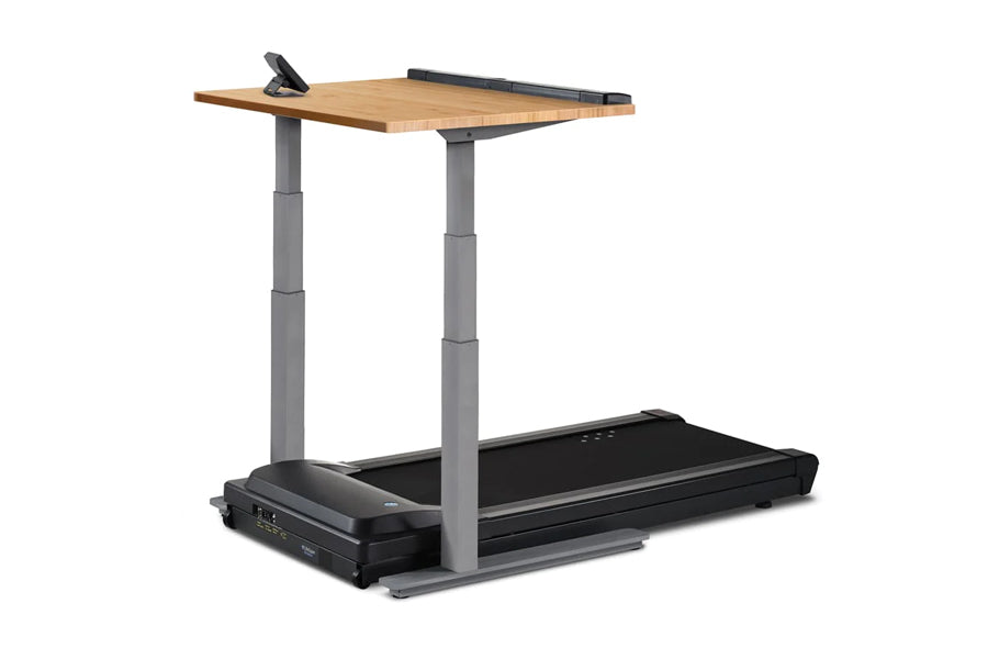 LifeSpan TR5000-Omni Desk Treadmill with black belt, gray columns, and natural wood desktop on white background