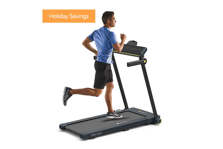 Man running on black LifeSpan TR650 Slim treadmill wearing blue shirt and black shorts, against white background