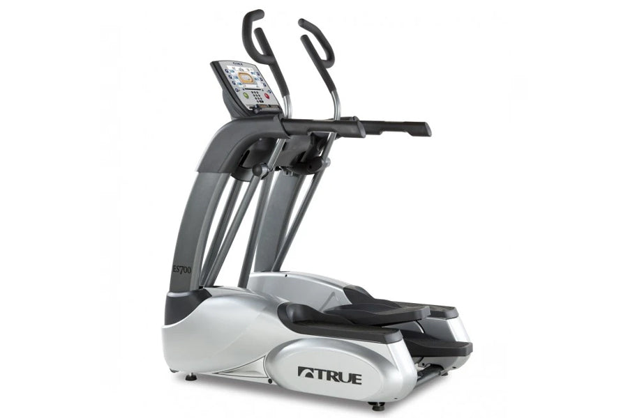 TRUE ES700 elliptical machine with white and gray frame, black handles, digital display console, and foot pedals on white bac