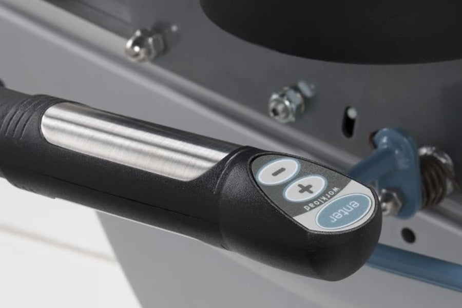 Black handlebar with white and blue control buttons including plus, minus, and display functions on recumbent bike