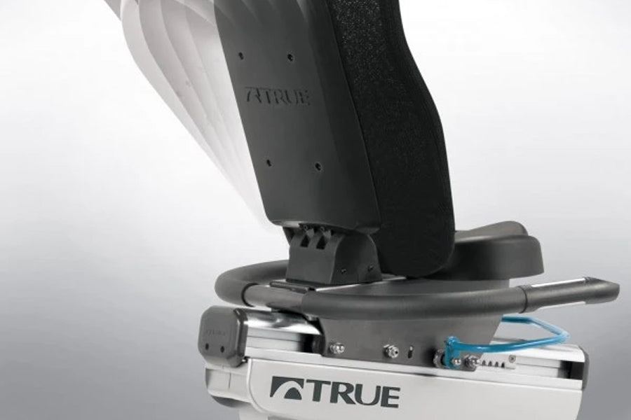 TRUE ES900 recumbent exercise bike with black and white frame, gray seat, and blue cable detail on white background