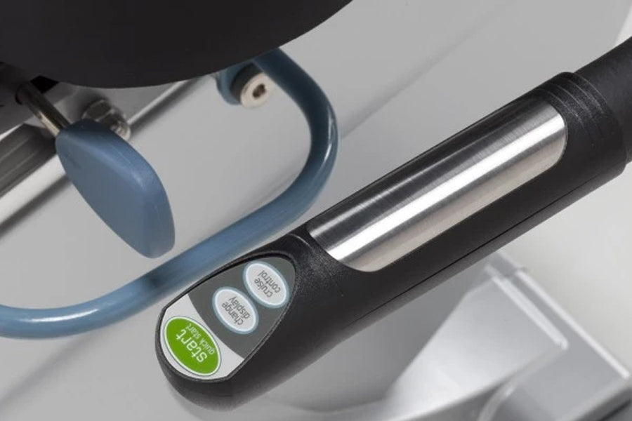 White recumbent exercise bike with blue foot pedal and black handle featuring green and gray control buttons, on white backgr