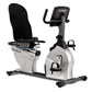 TRUE ES900 recumbent exercise bike with white frame, black seat and handlebars, digital display, and foot pedals on white bac