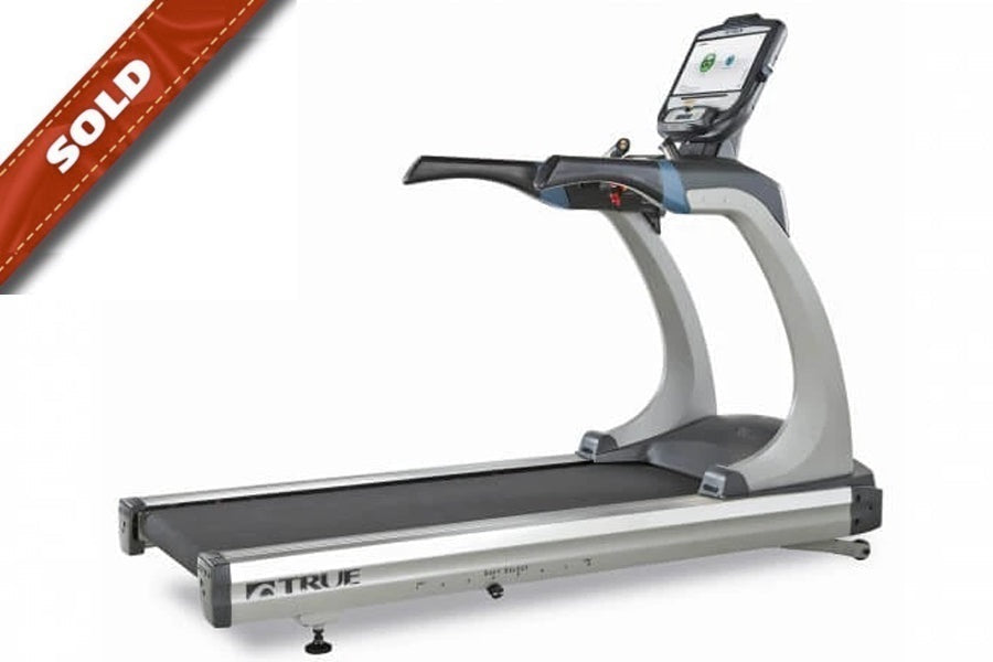 TRUE ES900 commercial treadmill with gray and silver frame, black running belt, and digital console mounted on handlebar, mar
