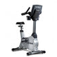 TRUE ES900 upright exercise bike with silver frame, black seat, and digital console, on white background