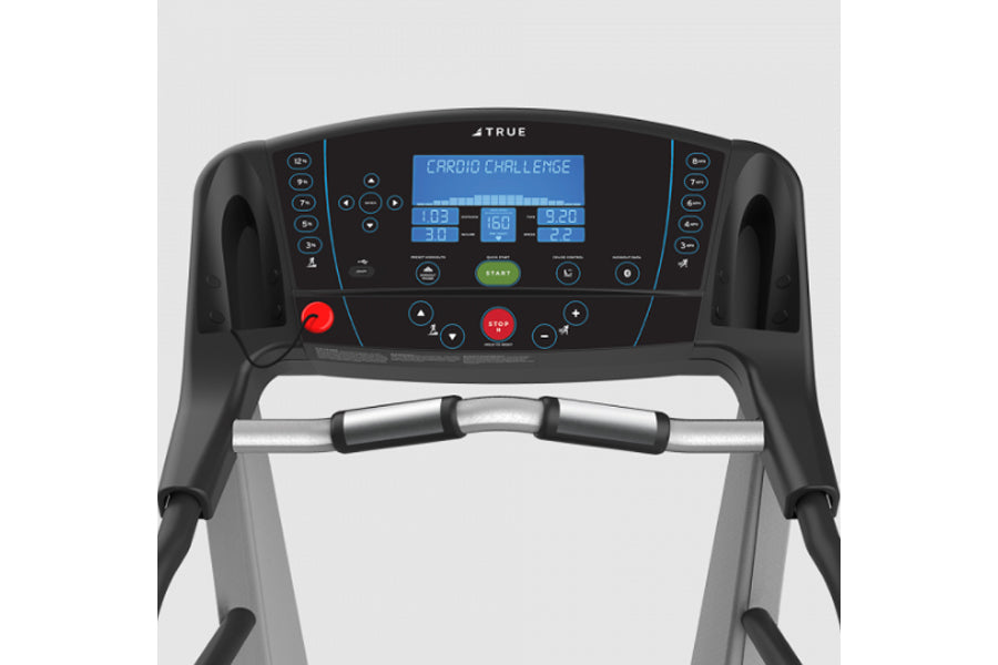 TRUE Z5.0 treadmill console with blue digital display showing cardio challenge metrics, black and silver frame with grip hand