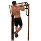 Teeter EZ-Ups inversion and chin-up rack system with wooden posts and black metal frame, demonstrated by shirtless male model
