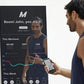 Man in navy tank top viewing lululemon Studio Mirror Plus on wall, displaying workout metrics and heart rate graph on black s
