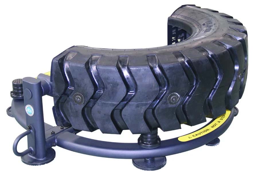 Warrior Tire Flip 180 fitness equipment with black curved tire and blue metal frame with pump handle on white background