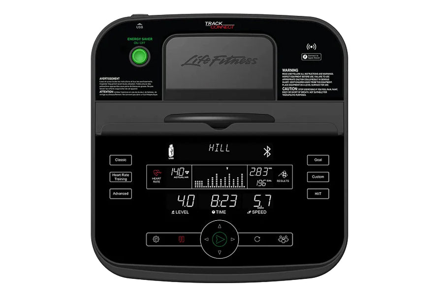 Life Fitness T5 treadmill console with black display screen showing workout metrics, green energy saver button, and control b