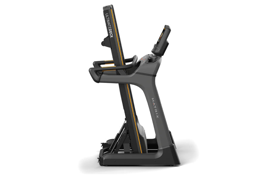 Matrix TF30 folding treadmill with black frame, gold accents, and dual handles on white background