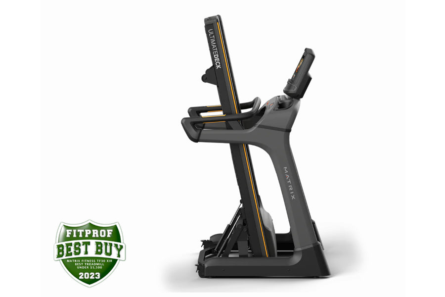 Black and gold Matrix TF30 folding treadmill with digital display console, displayed on white background