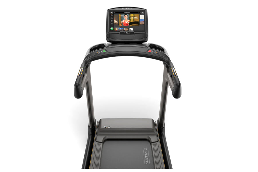 Black Matrix folding treadmill with interactive touchscreen console displaying workout content, viewed from front on white ba