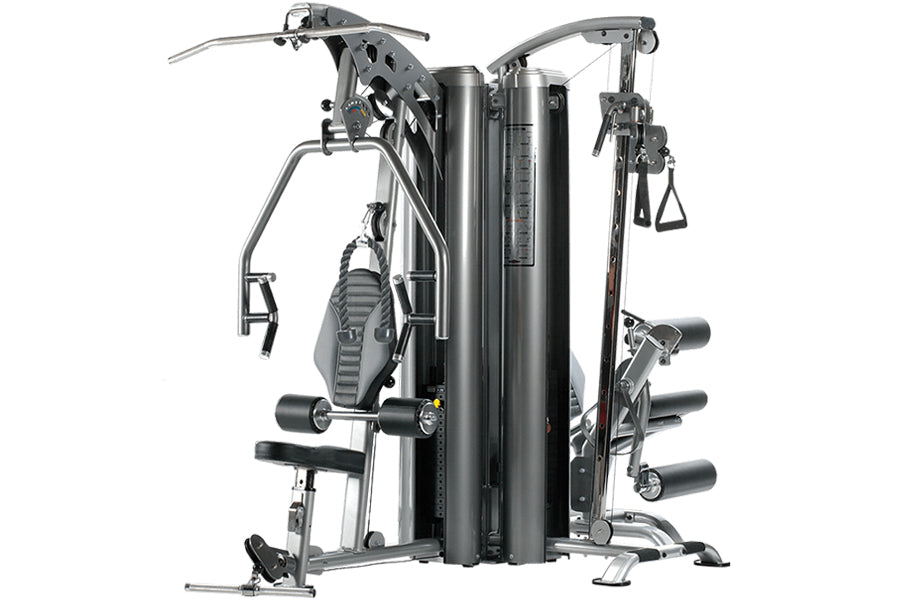 TuffStuff Apollo 7300 three-station multi-gym with black and silver frame, featuring multiple exercise stations with weight s