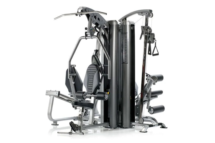 TuffStuff Apollo 7400 4-station multi-gym system with black padded seats, silver metal frame, and multiple exercise stations 
