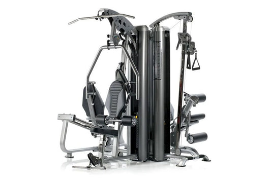TuffStuff Apollo 7400 4-station multi-gym system with black padded seats, silver metal frame, and multiple exercise stations 