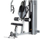 TuffStuff Apollo 7000 multi-press machine with silver frame, black seat, padded backrest, and weight stack on white backgroun