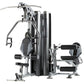 TuffStuff Apollo 7200 2-station multi gym system with dual weight stacks, padded seat and leg press platform on white backgro