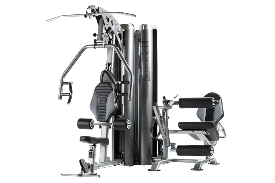 TuffStuff Apollo 7200 2-station multi gym system with dual weight stacks, padded seat and leg press platform on white backgro
