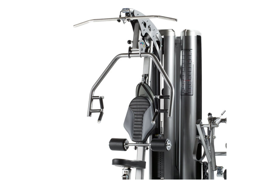 Silver and black multi-gym system with dual weight stacks, leg press station, and chest press attachment on white background